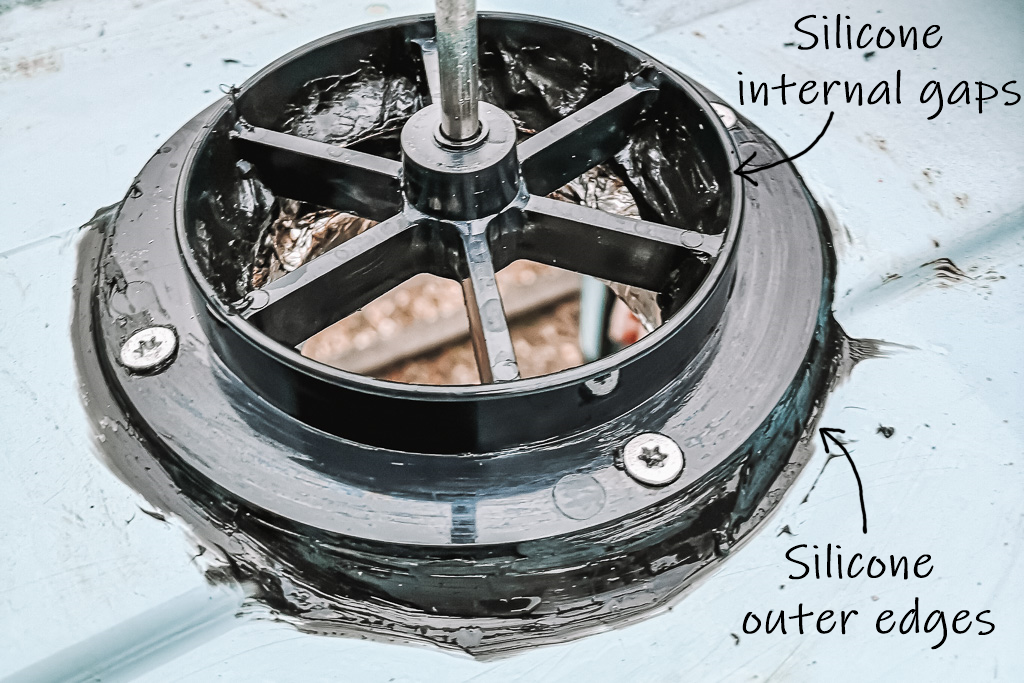 Annotated photo showing the gasket and vent base in place secured with silicone