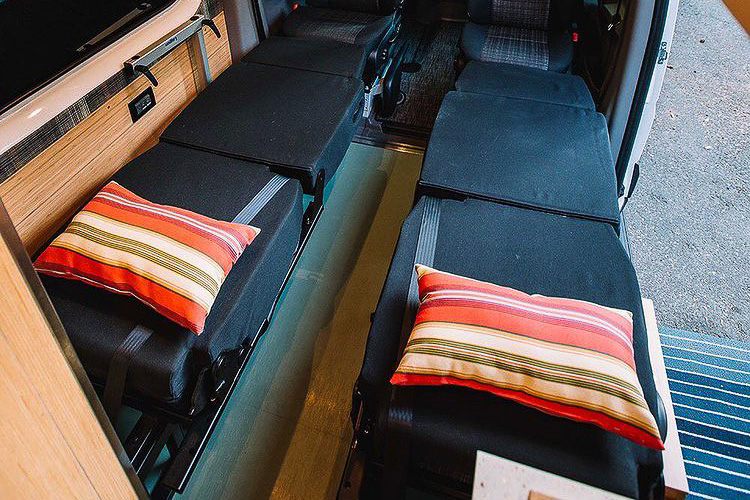 Two convertible single beds in a camper conversion