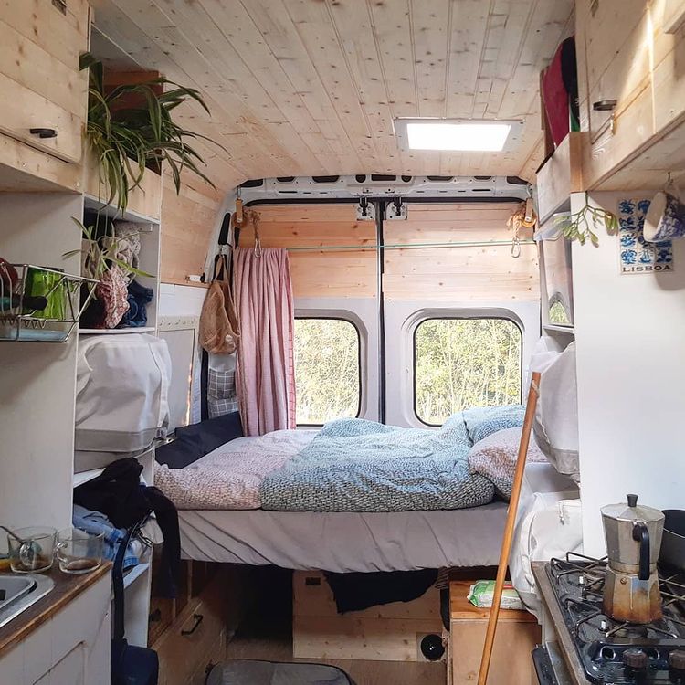A lowering bed and other campervan furniture in a DIY campervan build
