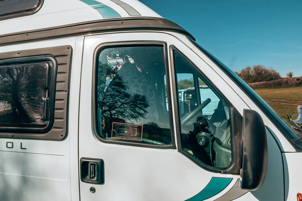 The cab windows of a converted campervan