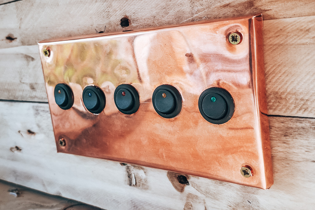 A copped mounted switch board for lights in a campervan conversion