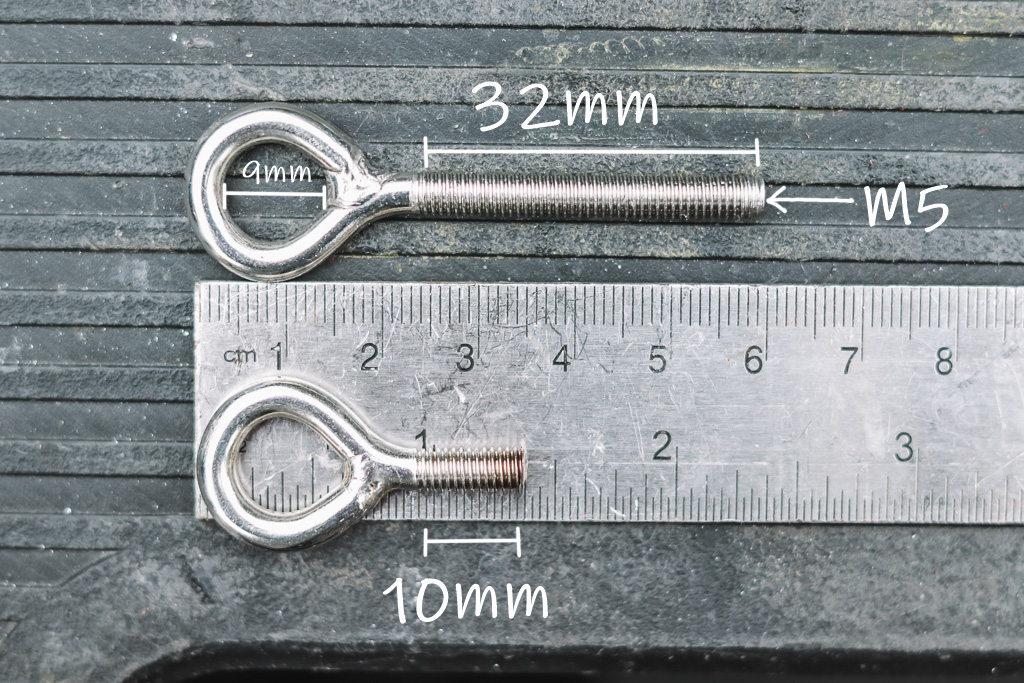 One eye bolt measuring 32mm and another measuring 10mm