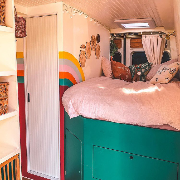 A fixed lengthways bed in a DIY camper van