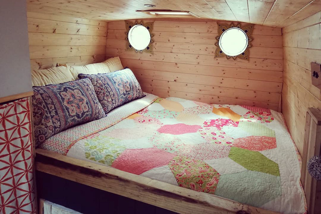 A fixed bed in a campervan layout