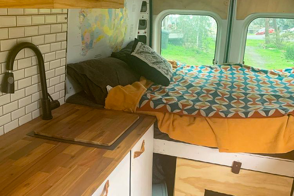 A bed in a medium wheelbase campervan layout