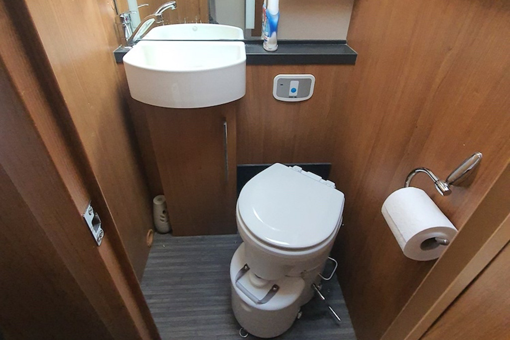 An air head composting toilet installed in a campervan bathroom