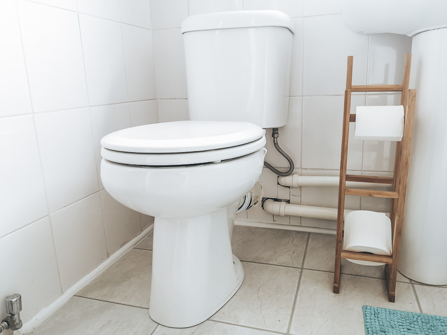 A household toilet in a white bathroom