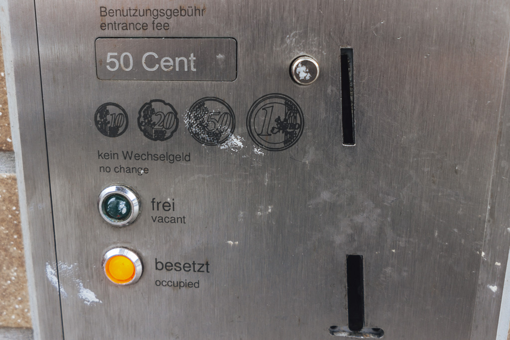 A sign for a public toilet in heidelberg showing that you must pay 50 cents