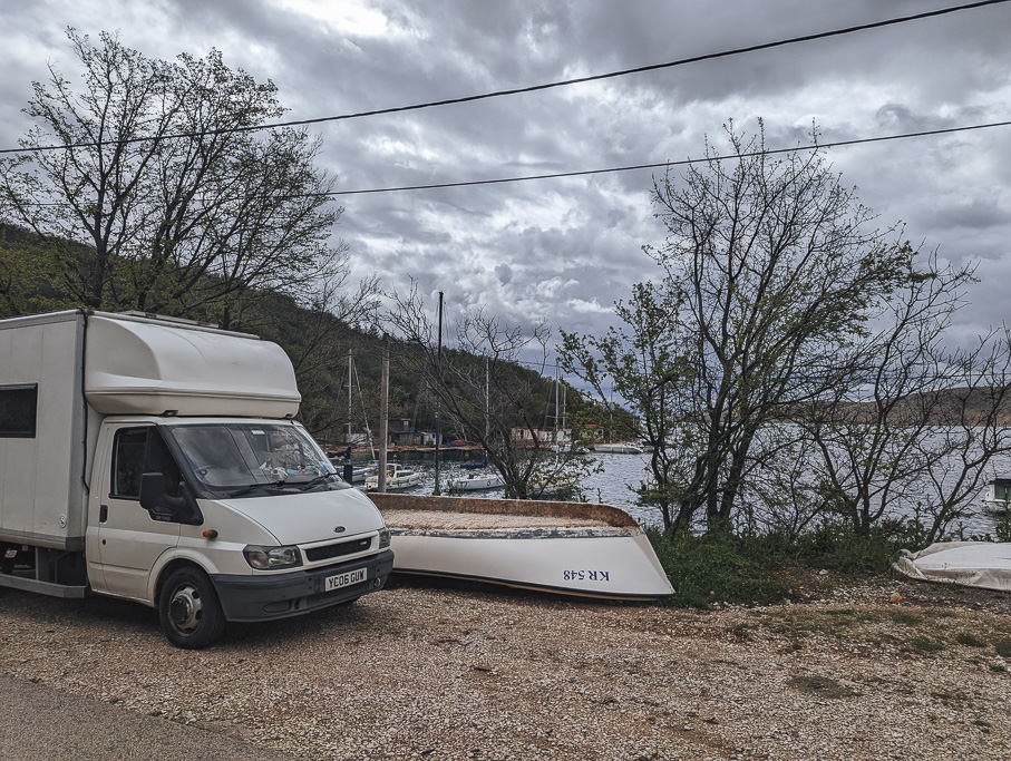 A Luton campervan parked by a harbour in croatia